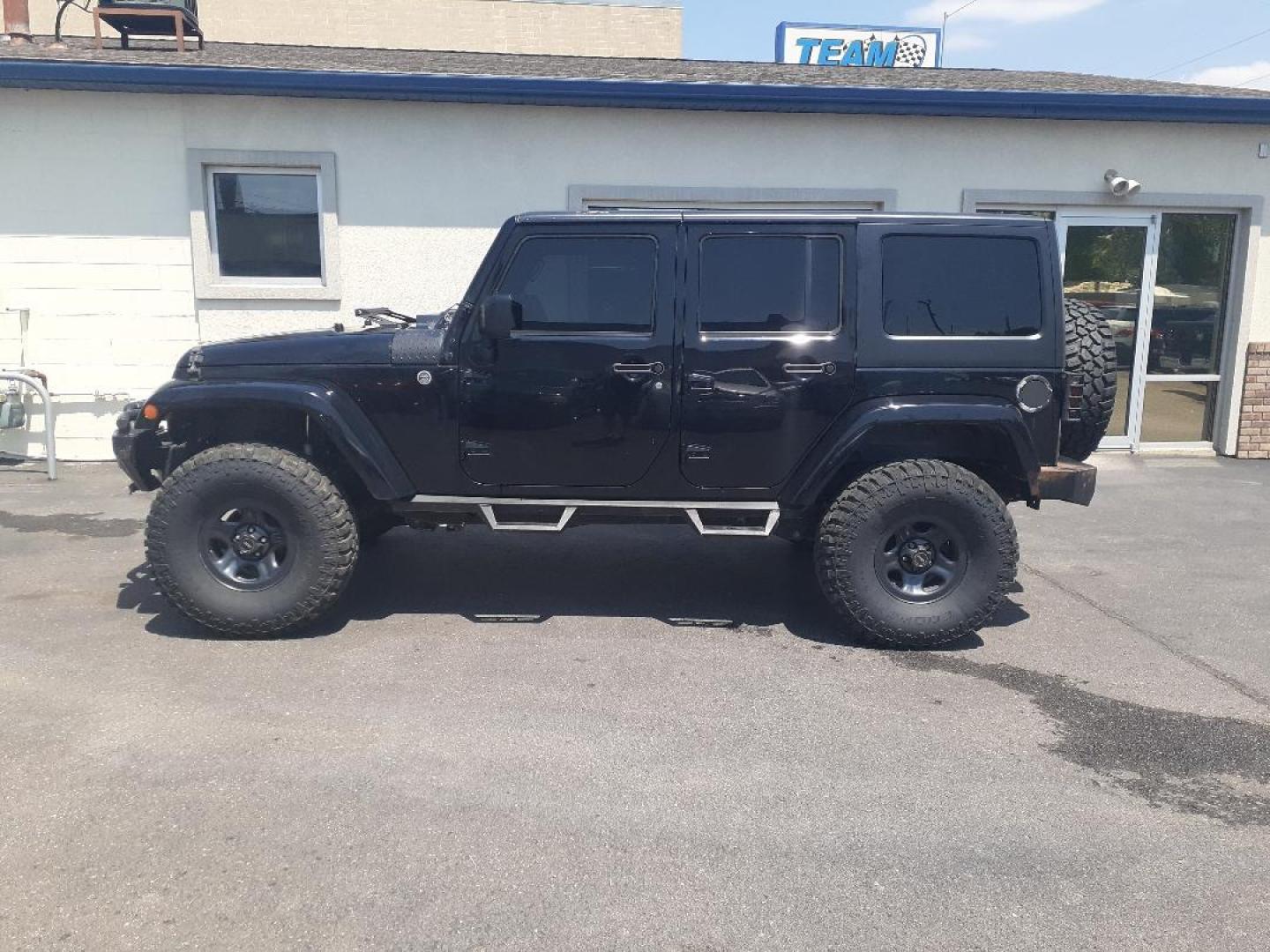 2015 Jeep Wrangler Unlimited Sahara 4WD (1C4BJWEGXFL) with an 3.6L V6 DOHC 24V FFV engine, located at 2015 Cambell Street, Rapid City, SD, 57701, (605) 342-8326, 44.066433, -103.191772 - CARFAX AVAILABLE - Photo#0