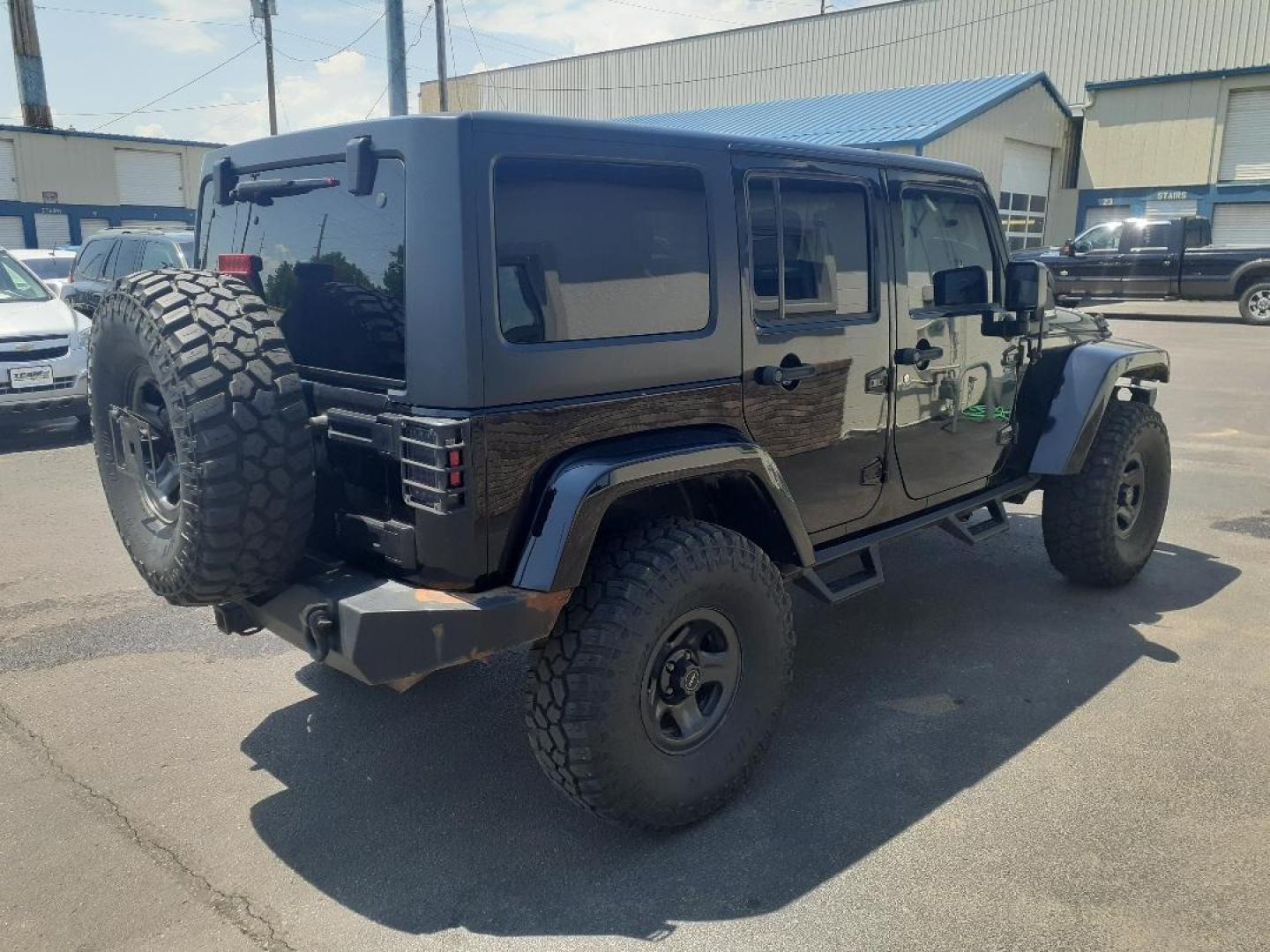 2015 Jeep Wrangler Unlimited Sahara 4WD (1C4BJWEGXFL) with an 3.6L V6 DOHC 24V FFV engine, located at 2015 Cambell Street, Rapid City, SD, 57701, (605) 342-8326, 44.066433, -103.191772 - CARFAX AVAILABLE - Photo#4