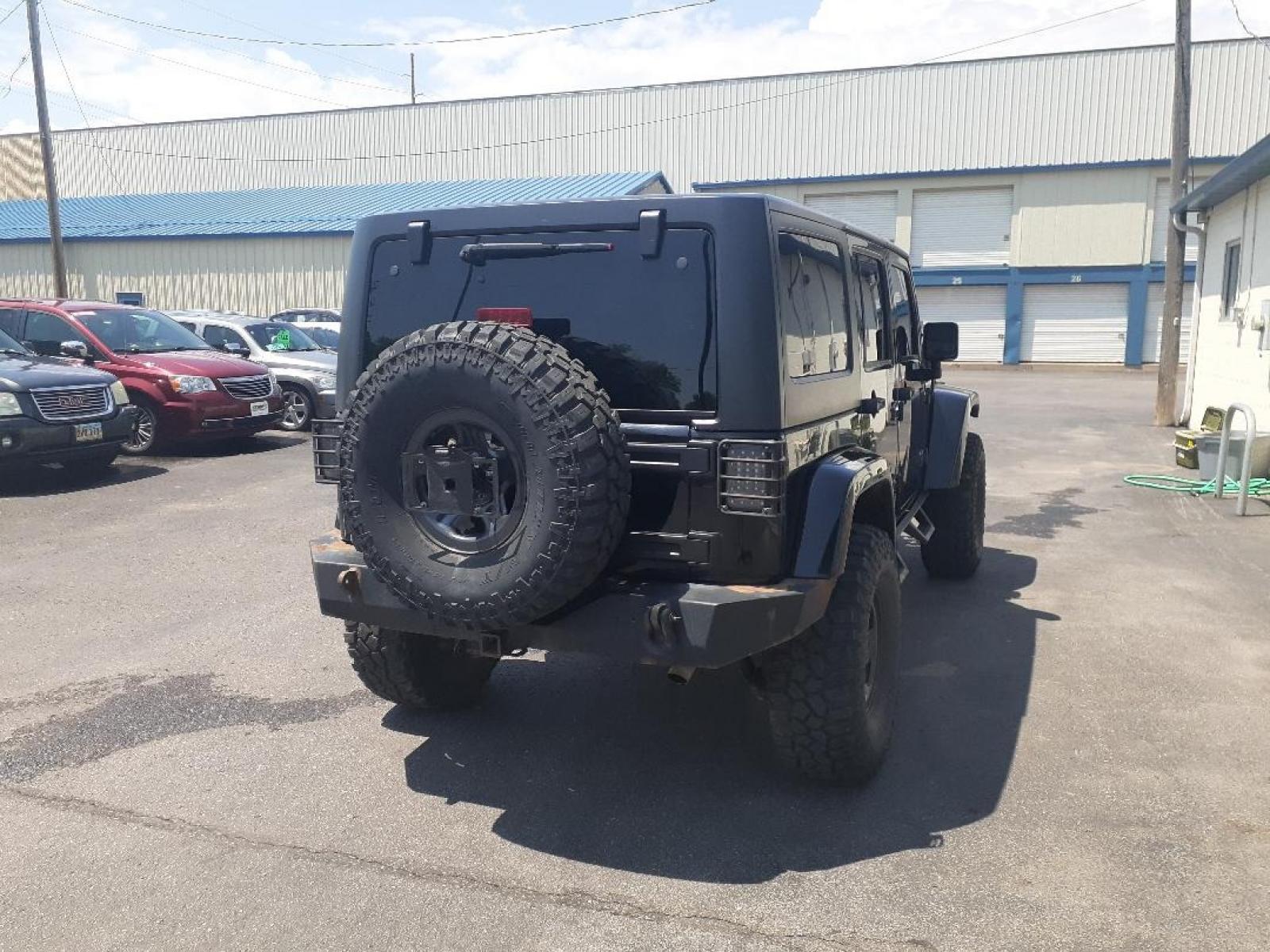 2015 Jeep Wrangler Unlimited Sahara 4WD (1C4BJWEGXFL) with an 3.6L V6 DOHC 24V FFV engine, located at 2015 Cambell Street, Rapid City, SD, 57701, (605) 342-8326, 44.066433, -103.191772 - CARFAX AVAILABLE - Photo #6