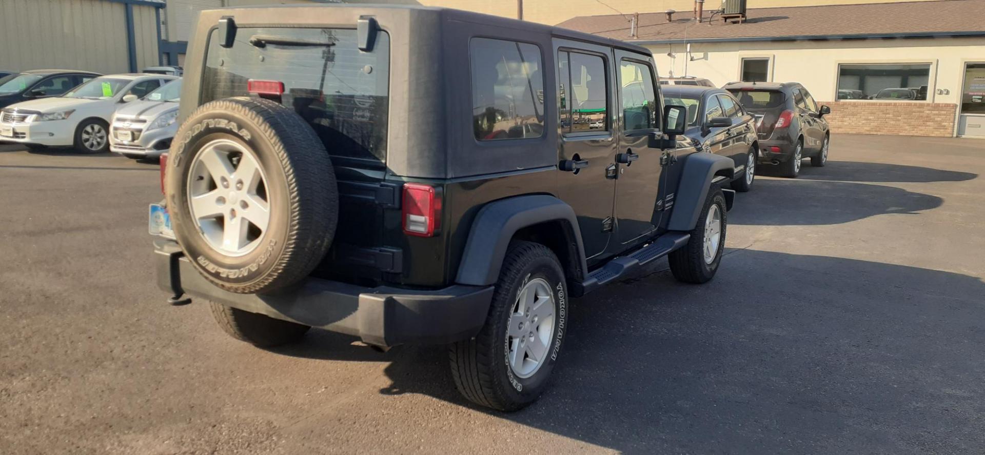 2011 Jeep Wrangler Unlimited Sport 4WD (1J4BA3H13BL) with an 3.8L V6 OHV 12V engine, located at 2015 Cambell Street, Rapid City, SD, 57701, (605) 342-8326, 44.066433, -103.191772 - CARFAX AVAILABLE - Photo#4